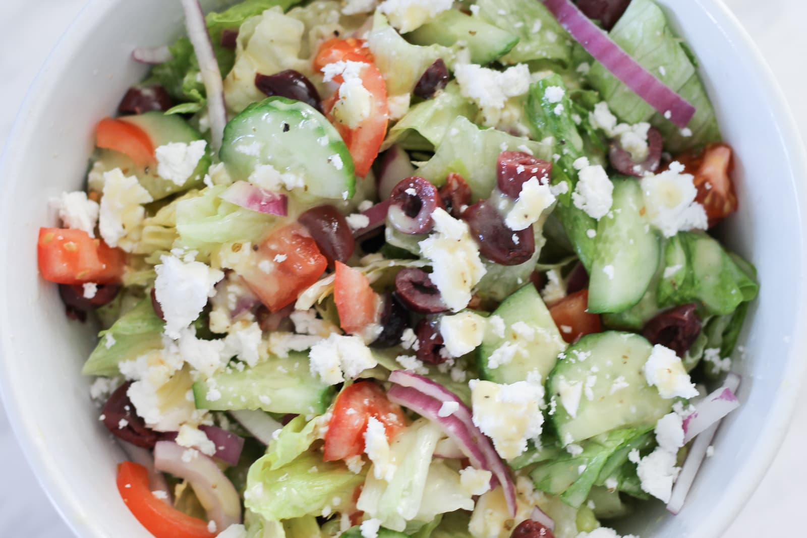 White bowl filled with Greek Salad.