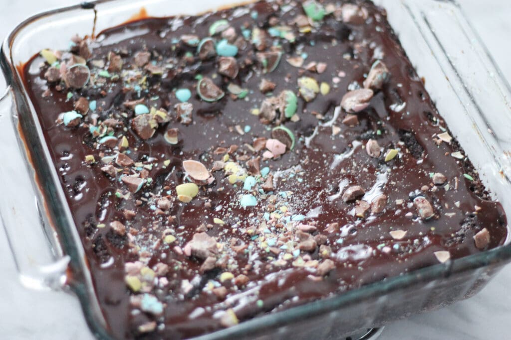 Finished brownies in glass baking dish with crushed Mini Eggs on top.